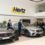 Hertz car rental office in Dubai with luxury vehicles on display