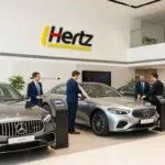Hertz car rental office in Dubai with luxury vehicles on display